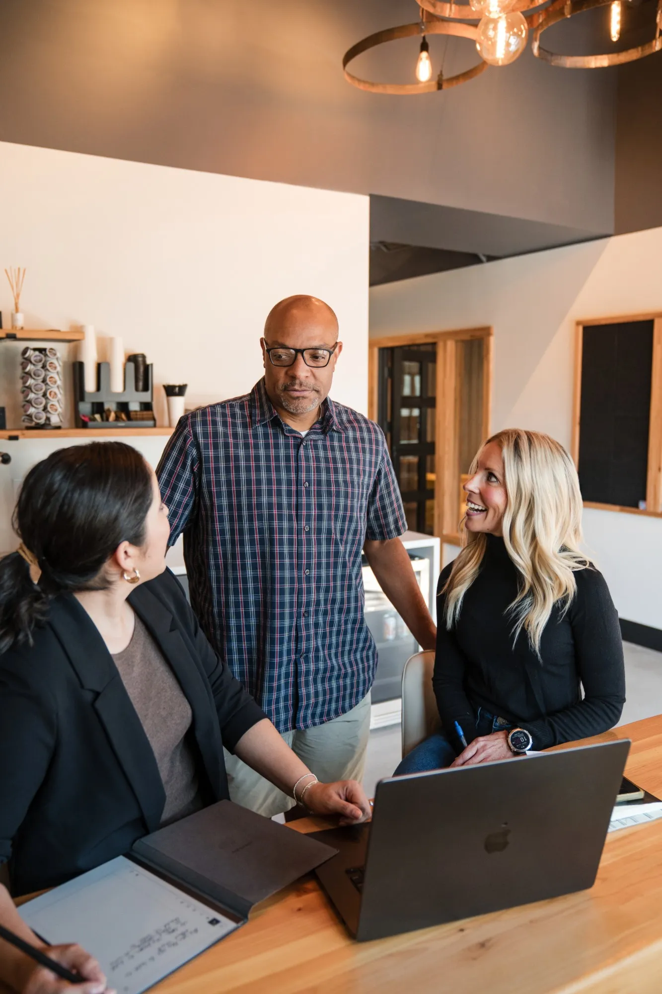 Jen Orvis talking with two people at a table